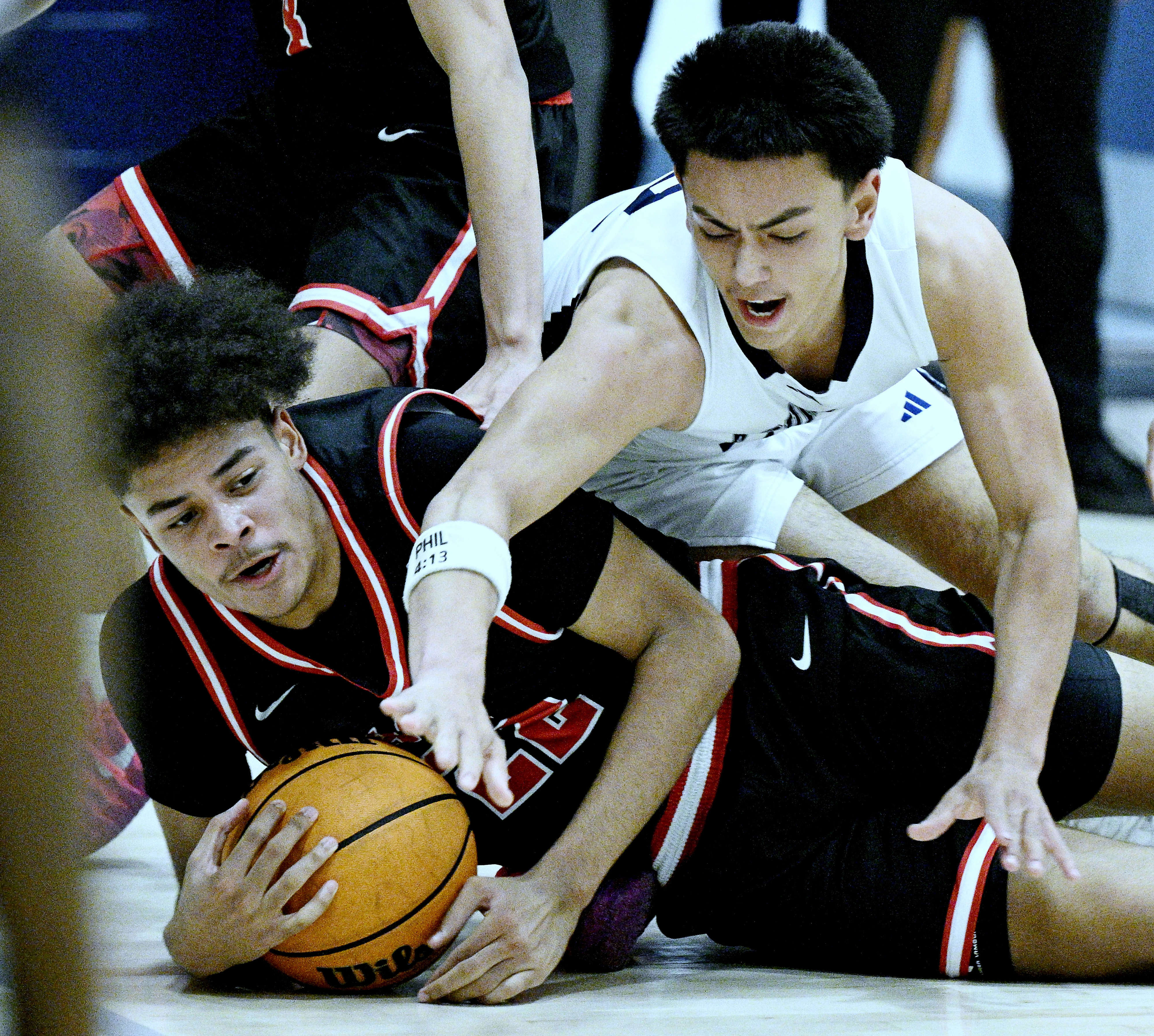 Arrowhead Christian Academy forward Anthony Gerome (22) fights for the...