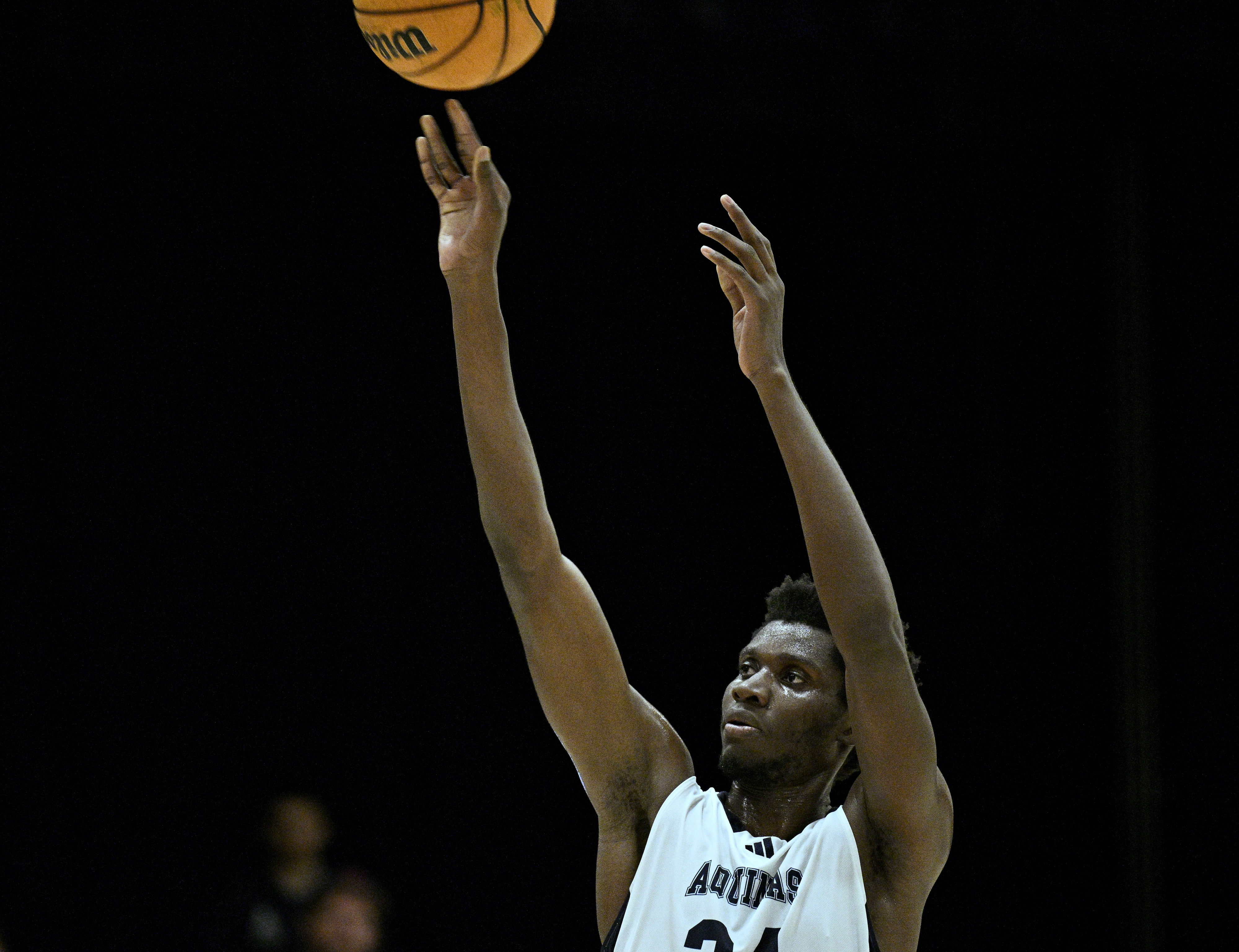 Aquinas forward Jumaa Kitendo (34) shoots against Arrowhead Christian Academy...