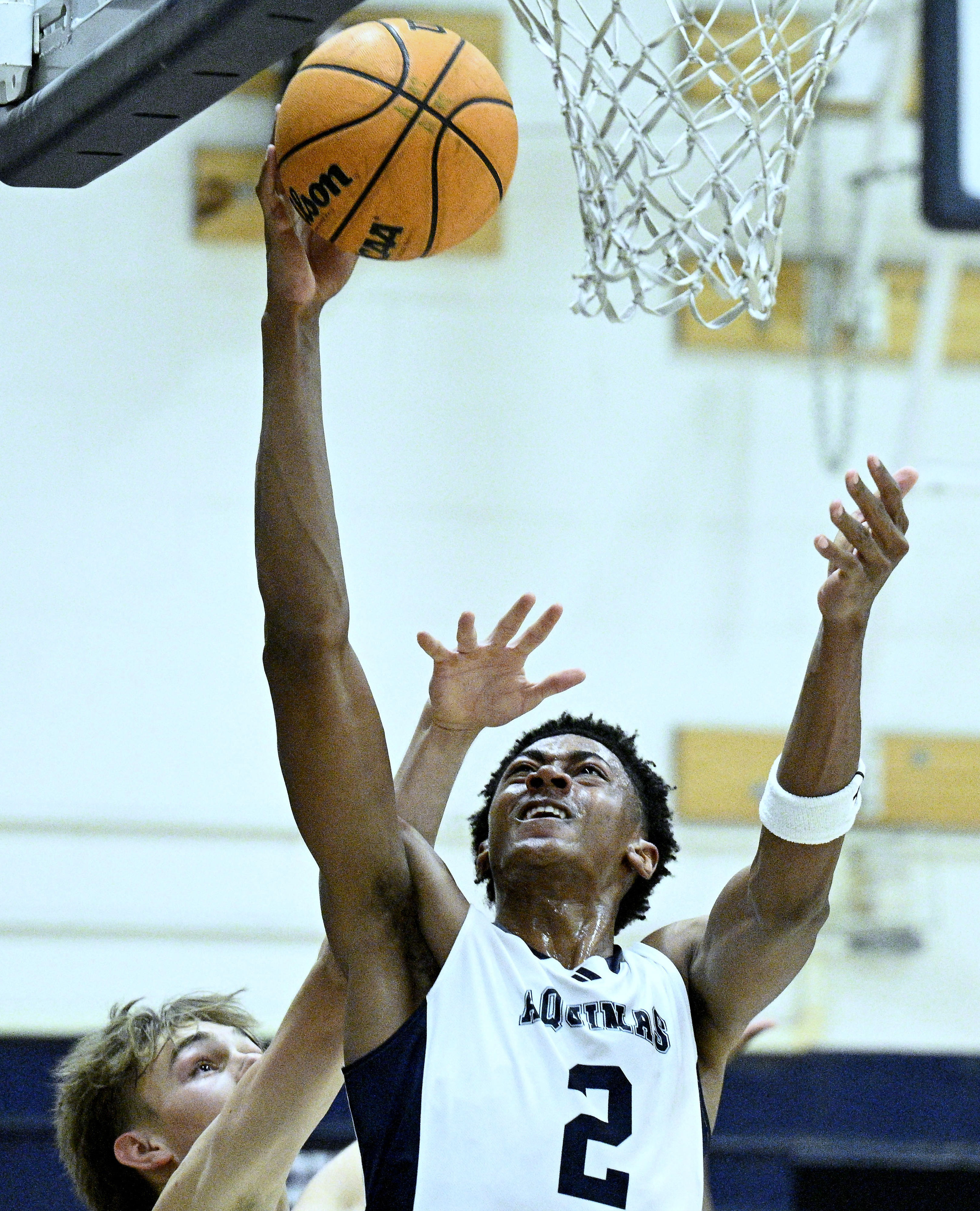 Aquinas forward Brooklyn Ross (2) makes the putback against Arrowhead...