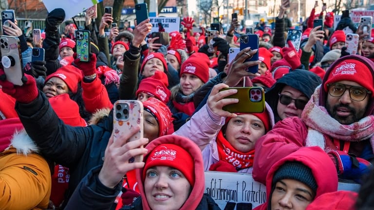 Members of the New York State Nurses Association union listen...