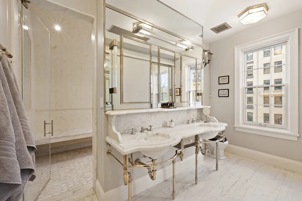 Modern bathroom featuring two sinks and a glass shower.