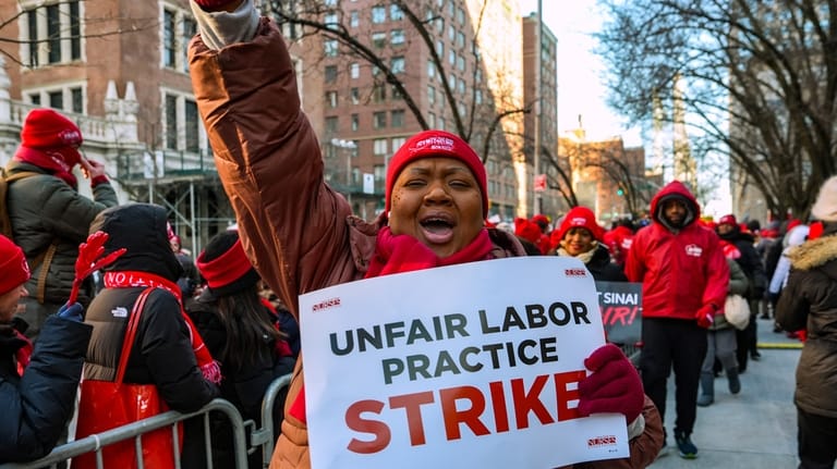 Members of the New York State Nurses Association union picket...