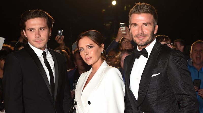 From left: Brooklyn Beckham, Victoria Beckham and David Beckham attend the GQ magazine's 2019 "Men of the Year" Awards at the Tate Modern on September 3, 2019 in London.
