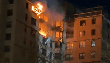 Emergency crews rush to huge blaze engulfing upper floors of high-rise