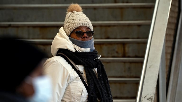 Lesley Williamson, bundled in a hat, scarf, neck gaiter and...