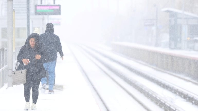 Veronica Bercian, of Central Islip, battles the cold and snow...
