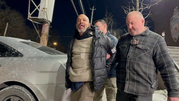 Samuel Calderon, 55, is escorted from the 47th precinct house by NYPD Detectives on Jan. 28, 2026. (Kerry Burke/NYDN) 