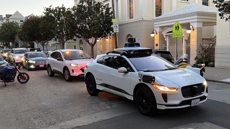 A Waymo driverless taxi stops for several minutes in San...