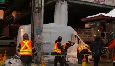 Van encased in frozen waterfall caused by dripping pipe in the Bronx by subway station