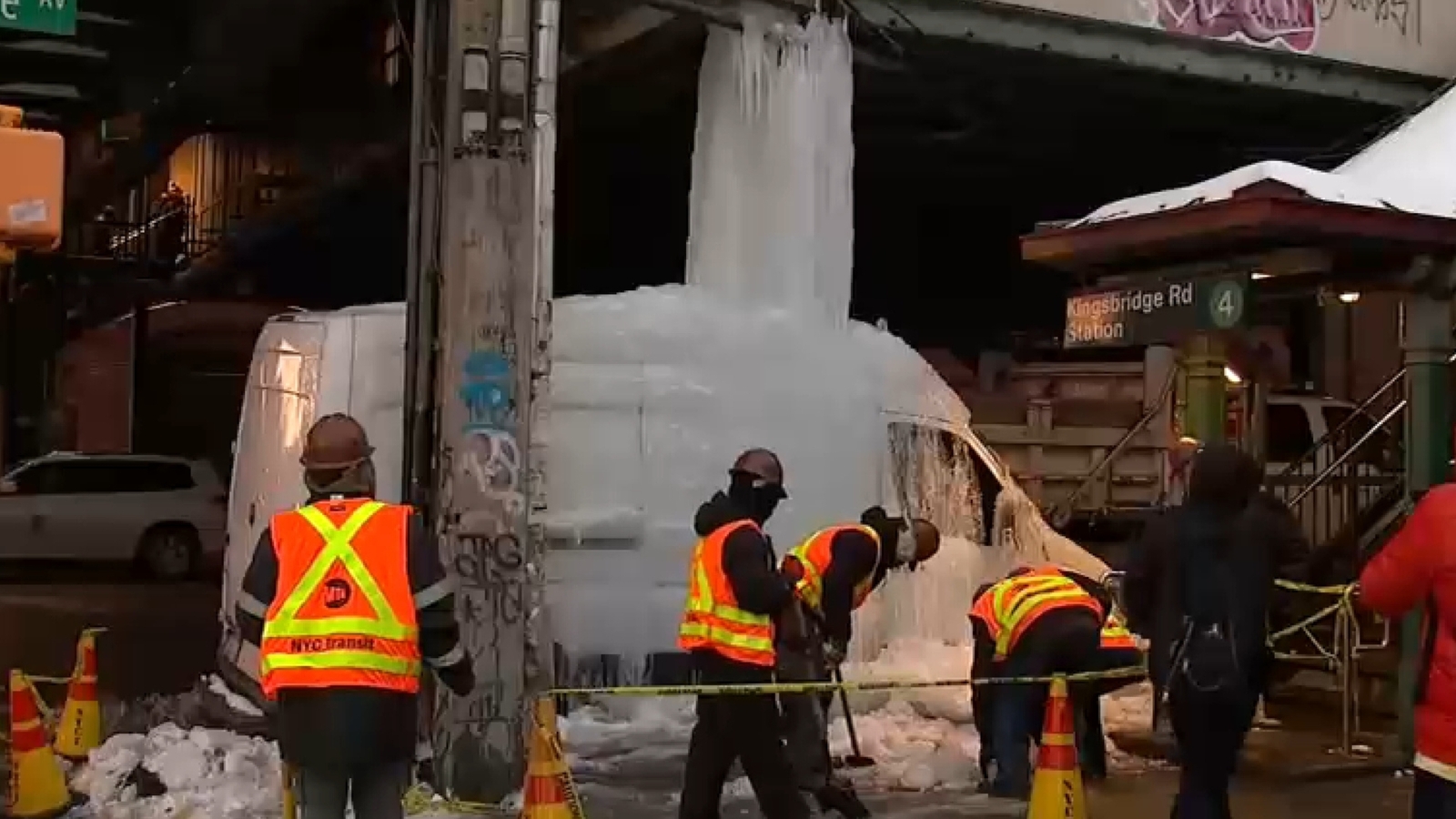 Van encased in frozen waterfall caused by dripping pipe in the Bronx by subway station