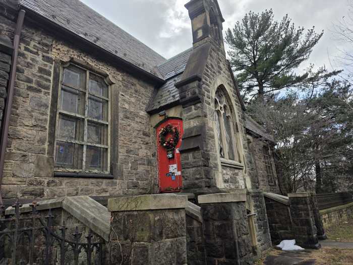 A historic chapel from the 1850s, made of stone with a bright red door, is home to the Bronx Academy of Arts and Dance.