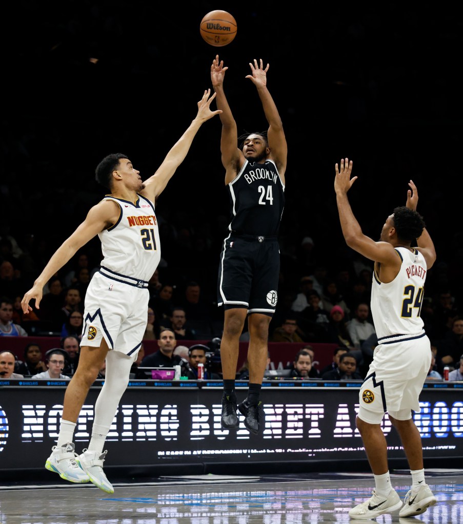 Cam Thomas #24 of the Brooklyn Nets puts up a shot over Spencer Jones #21 of the Denver Nuggets in the second half. The Brooklyn Nets defeat the Denver Nuggets at the Barclays Center.