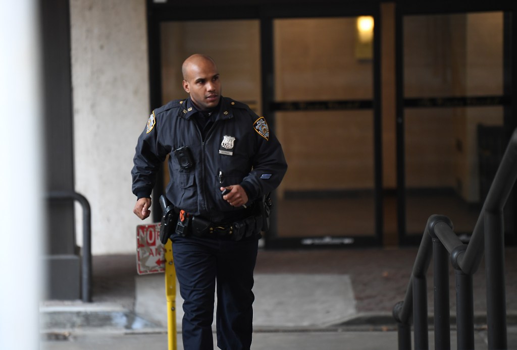 An NYPD officer responds to a shooting at 2500 Johnson Ave. in the Bronx.
