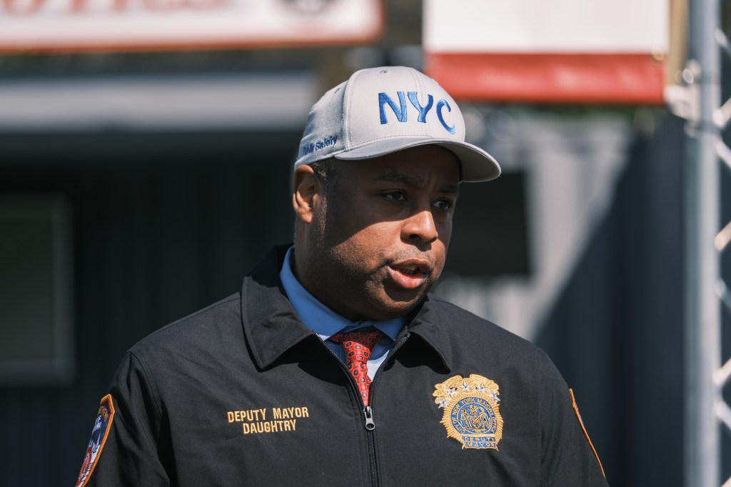 Deputy Mayor Daughtry wearing an NYC cap.