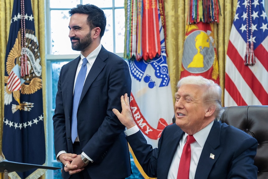 Donald Trump pats Zohran Mamdani on the arm in the Oval Office.