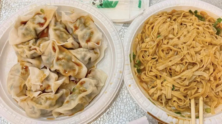 Dumplings and noodles served on disposable plates at Shu Jiao Fu Zhou