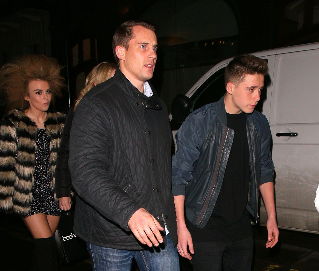 Tallia Storm, Brooklyn Beckham and a bodyguard walking together