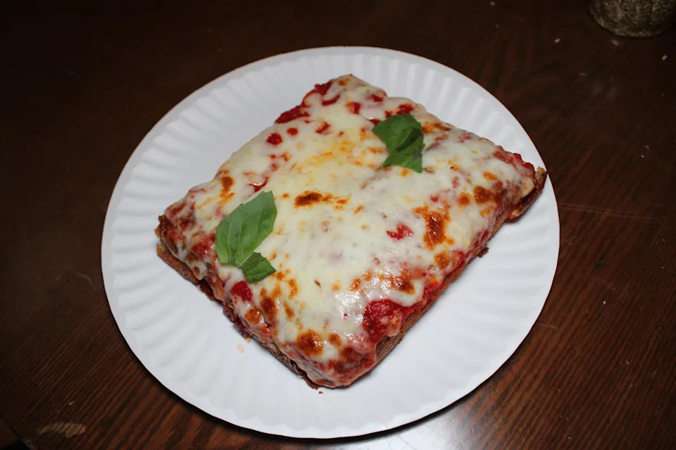 Cheesy square slice of pizza