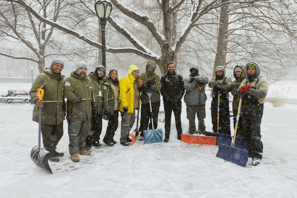 Mayor Zohran Mamdani with Parks Department members in snowy NYC during a winter storm.