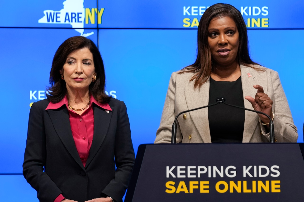 Kathy Hochul and Letitia James at a lectern that says "Keeping Kids Safe Online"