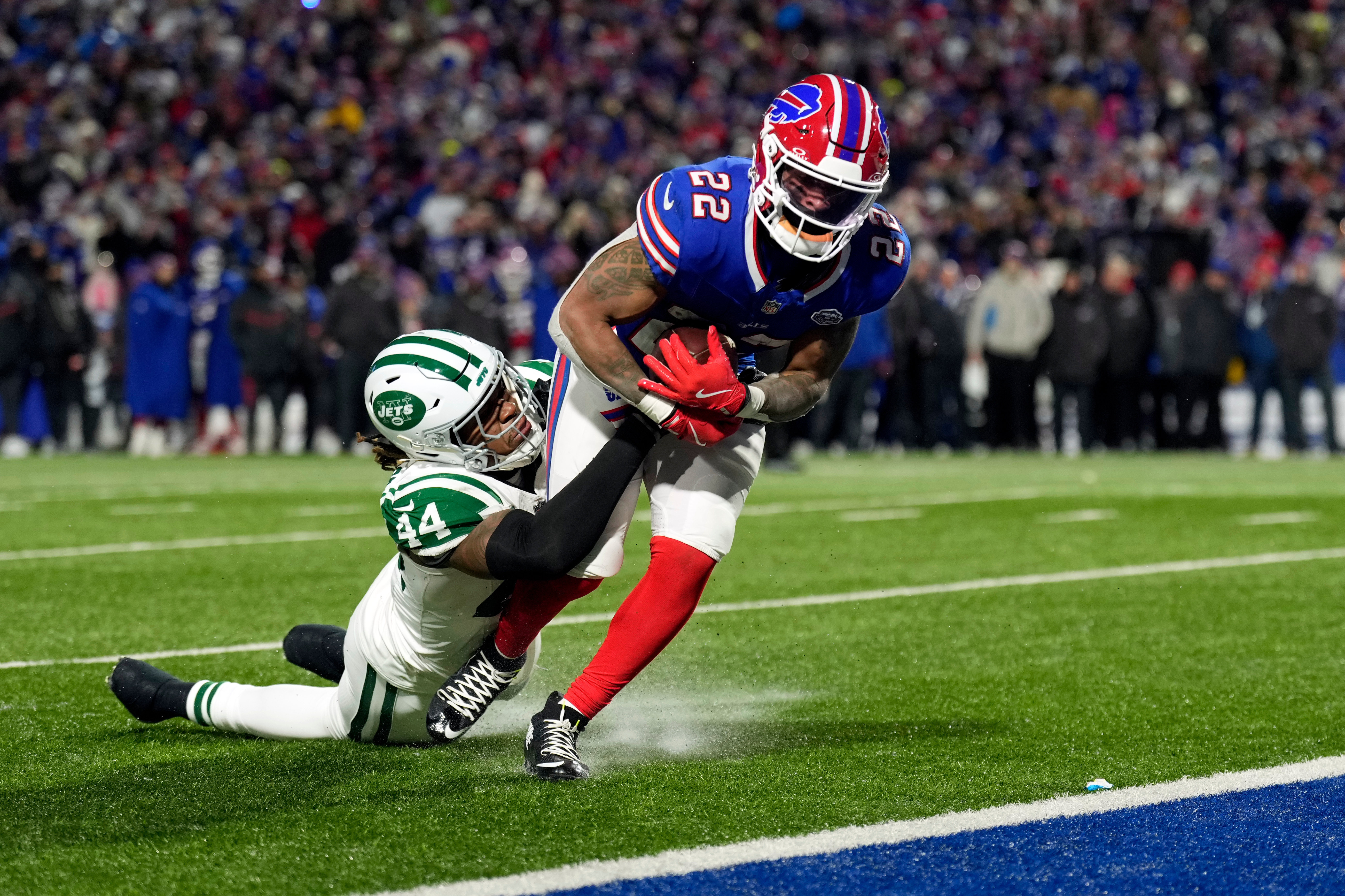 Buffalo Bills running back Ray Davis (22) gets past New York Jets linebacker Jamien Sherwood (44) as Davis scores a touchdown in the first half of an NFL football game Sunday, Jan. 4, 2026, in Orchard Park, N.Y. (AP Photo/Seth Wenig)