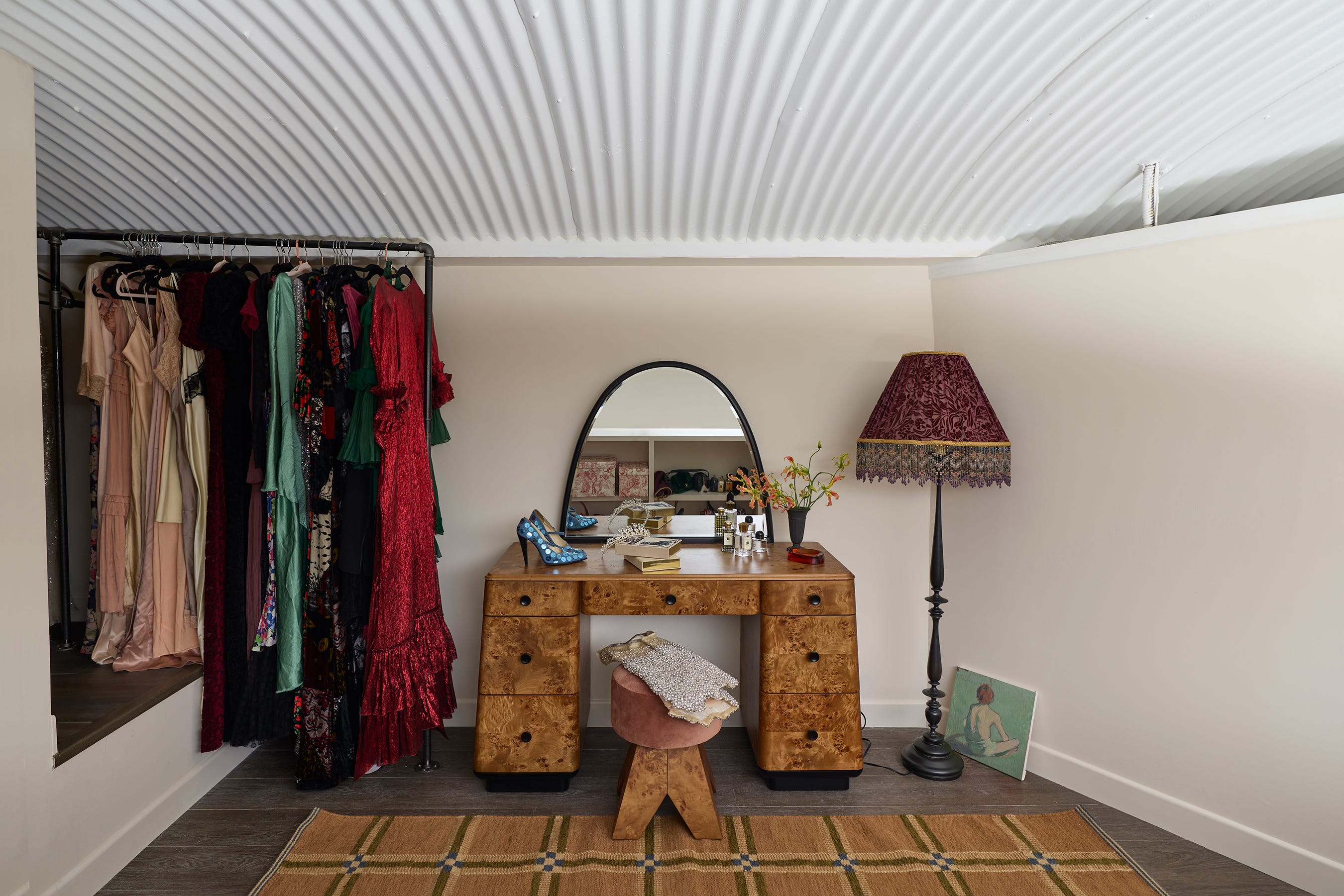 Dressing area featuring a clothing rack and vanity.