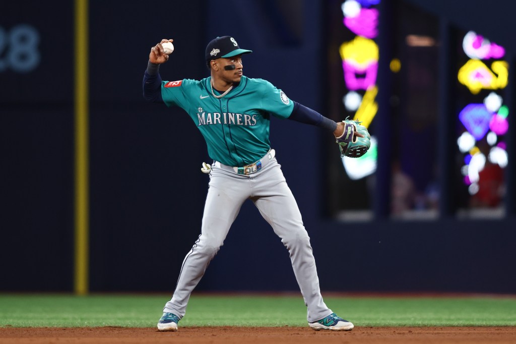 Jorge Polanco of the Seattle Mariners throwing a baseball to first base.