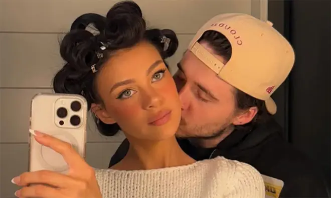 Brooklyn Beckham kissing wife Nicola Peltz on the cheek in a mirror selfie