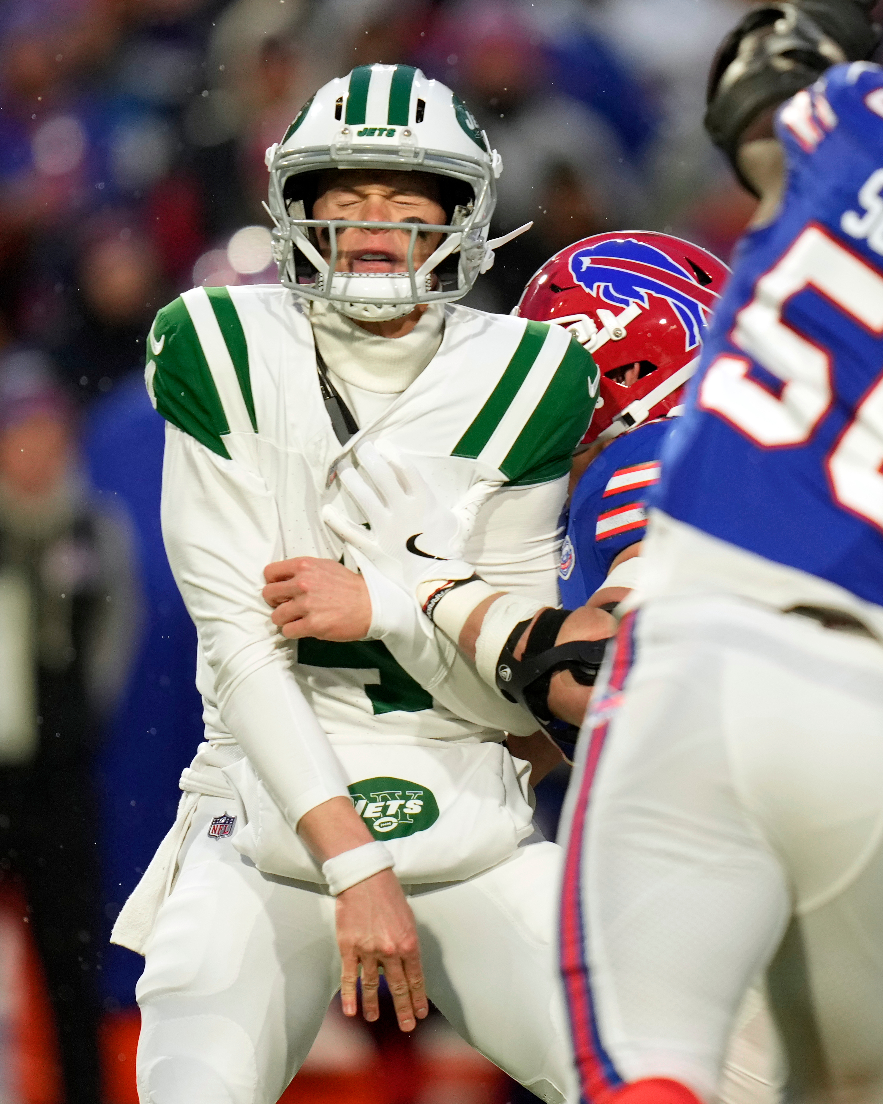 New York Jets quarterback Brady Cook (4) is hit as he throws against the Buffalo Bills in the first half of an NFL football game Sunday, Jan. 4, 2026, in Orchard Park, N.Y. (AP Photo/Seth Wenig)