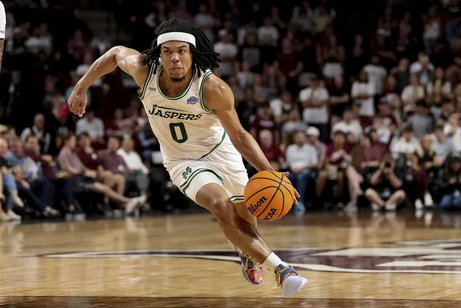 Nov 21, 2025; College Station, Texas, USA; Manhattan Jaspers guard Devin Dinkins (0) dribbles the ball during the second half against the Texas A&M Aggies at Reed Arena.Maria Lysaker-Imagn Images