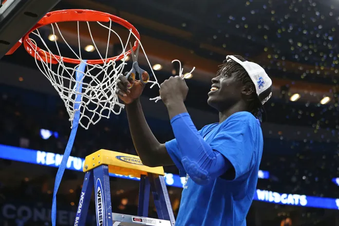Mar 11, 2018; St. Louis, MO, USA; Kentucky Wildcats forward Wenyen Gabriel (32) cuts down the net after the Wildcats defeat the Tennessee Volunteers in the SEC Conference Tournament Championship game at Scottrade Center. Kentucky won 77-72. Mandatory Credit: Billy Hurst-USA TODAY Sports