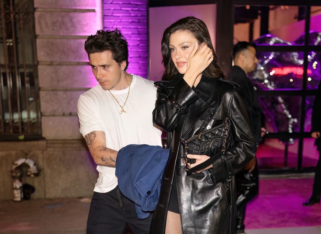 A photo of Brooklyn Beckham and Nicola Peltz walking