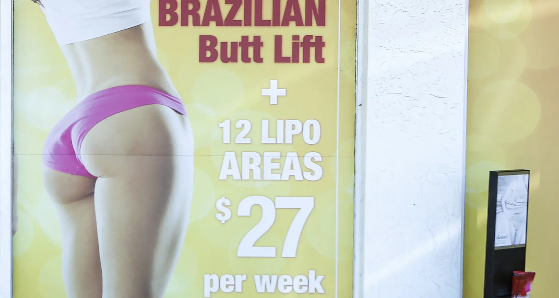 A window display advertises low-cost "Brazilian butt lift" cosmetic surgery procedures outside a clinic in Miami on Friday, March 22, 2019. On Thursday, Jan. 25, 2024, the Centers for Disease Control and Prevention said 93 Americans have died after cosmetic surgery in the Dominican Republic since 2009, with many of the recent deaths involving a procedure known as a Brazilian butt lift. Photo: Ellis Rua/AP