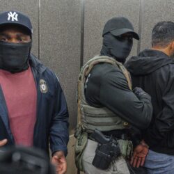 Immigration and Customs Enforcement agents escort a detained immigrant into an elevator after he exited an immigration courtroom, Tuesday, June 17, 2025, in New York. Photo: Olga Fedorova/AP