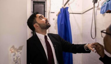 Mayor Zohran Mamdani visits Nadege Romulus, right, in her apartment on Clarkson Avenue in the Prospect Lefferts Garden neighborhood of Brooklyn, in New York, on the first day in office, on Thursday, Jan. 1, 2026. (Dave Sanders/The New York Times, Pool via AP)