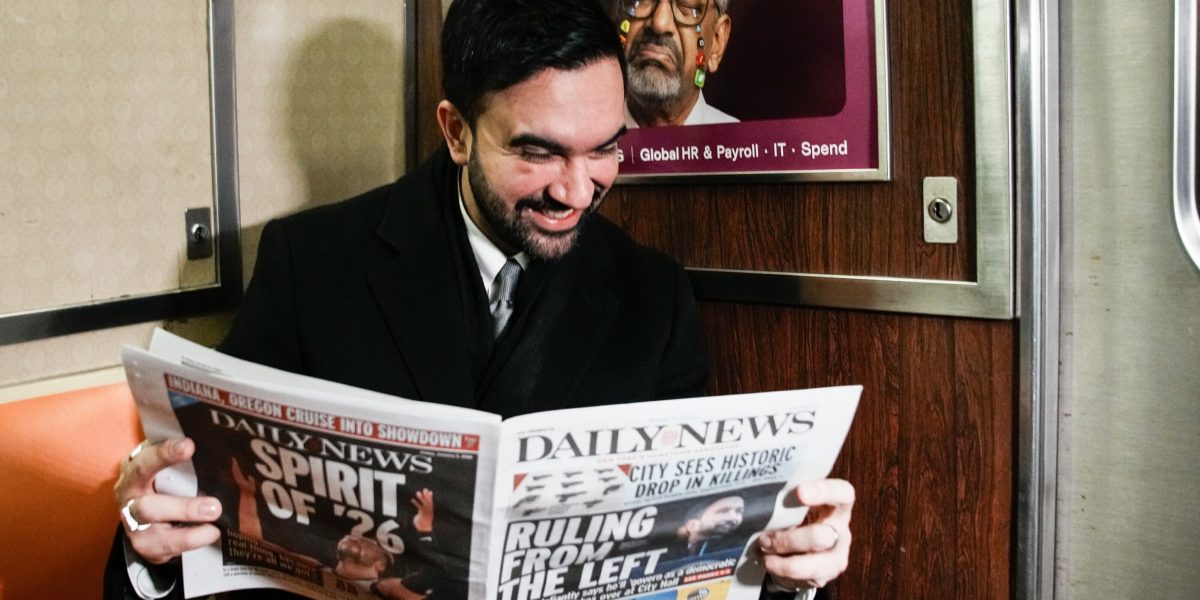 French tourists didn't believe the young guy on the subway was New York City's new mayor, so he held up the newspaper to prove it
