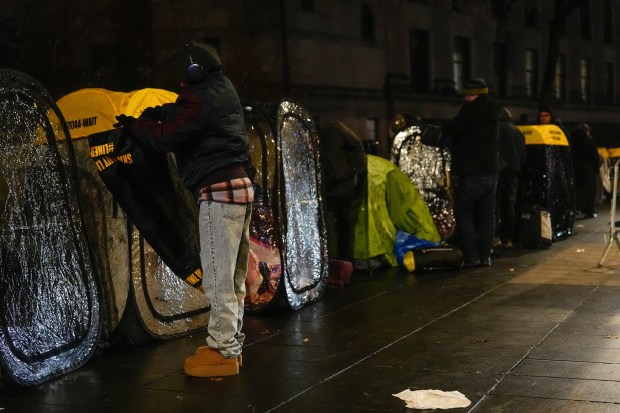 Line holders camp outside Manhattan Federal Court for Venezuelan President Nicolas Maduro's appearance, Monday, Jan. 5, 2026, in New York. (AP Photo/Yuki Iwamura)