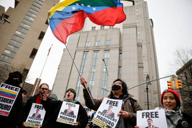 Protesters hold signs calling for the release of Venezuelan President Nicolas Maduro outside Manhattan Federal Court before his arraignment in New York, Monday, Jan. 5, 2026. (AP Photo/Stefan Jeremiah)