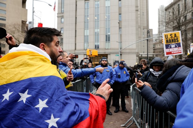 People protest outside Manhattan Federal Court before the arraignment of Venezuelan President Nicolas Maduro, Monday, Jan. 5, 2026, in New York. (AP Photo/Stefan Jeremiah)