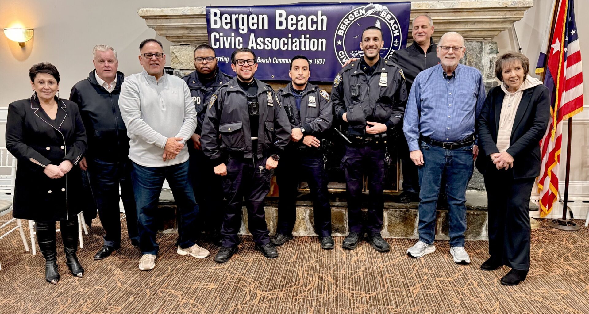 From left: Irina Khlevner, Donald Cranston, Michael Trotta, officers of the 63rd Precinct, Sal Calise, Michael Benjamin and Sue Ann Partnow. Photo by Arthur De Gaeta