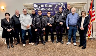 From left: Irina Khlevner, Donald Cranston, Michael Trotta, officers of the 63rd Precinct, Sal Calise, Michael Benjamin and Sue Ann Partnow. Photo by Arthur De Gaeta