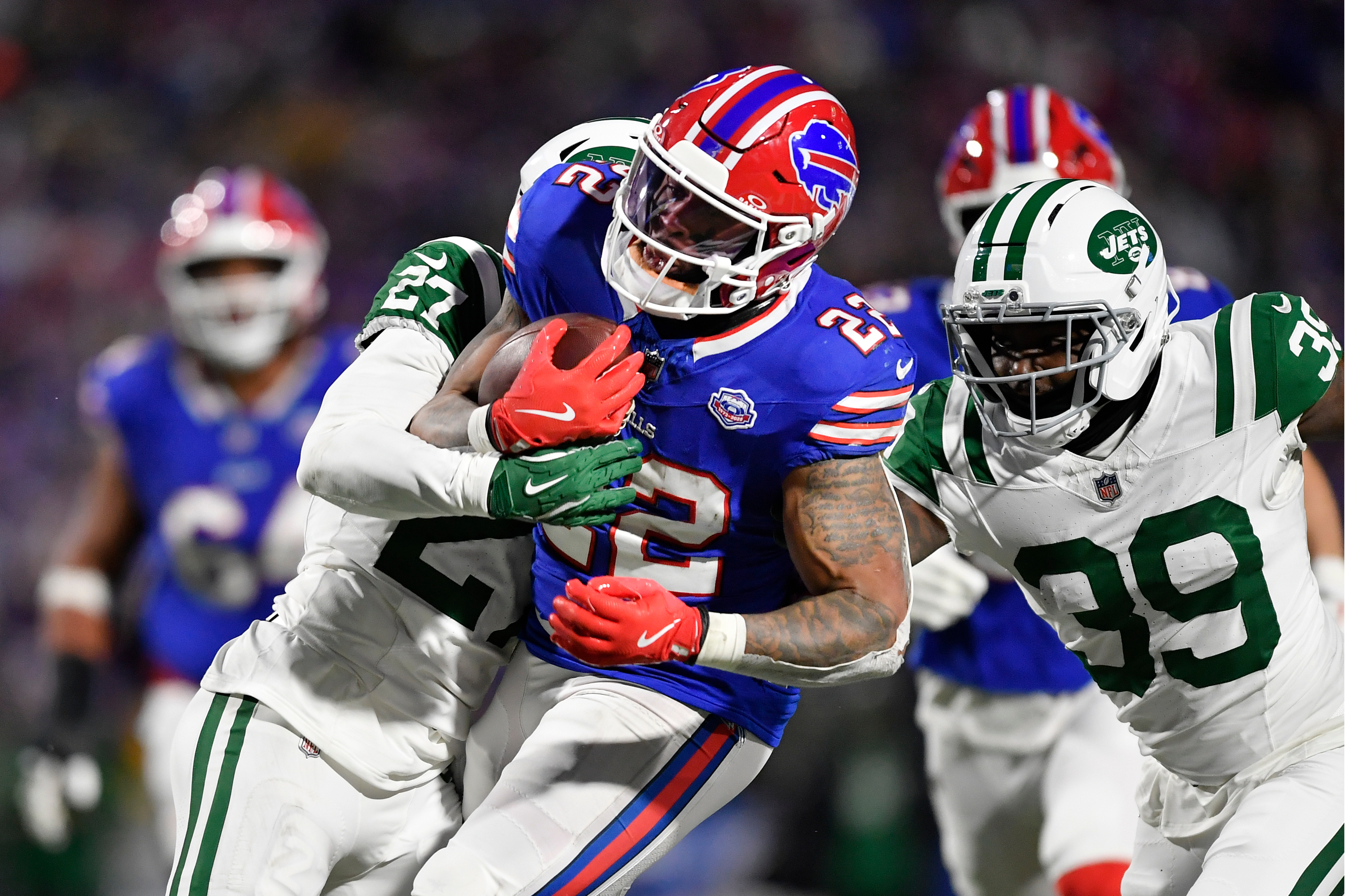 Buffalo Bills running back Ray Davis (22) carries the ball as he is defended by New York Jets safety Malachi Moore (27) in the first half of an NFL football game Sunday, Jan. 4, 2026, in Orchard Park, N.Y. (AP Photo/Adrian Kraus)