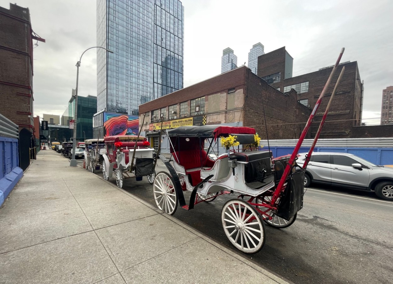 Carriages lined up outside West Side Livery Stables on W38th Street
