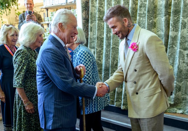 LONDON, ENGLAND - MAY 20: David Beckham wearing a David Austin Roses "King's Rose" speaks with King Charles III, patron of the Royal Horticultural Society during a visit to the RHS Chelsea Flower Show at Royal Hospital Chelsea on May 20, 2025 in London, England. (Photo by Paul Grover - WPA Pool/Getty Images)