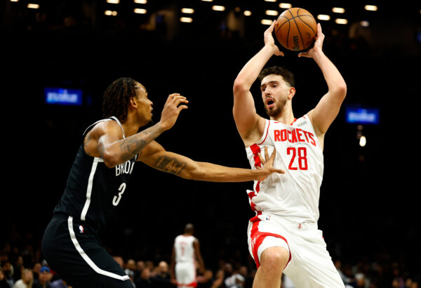 Brooklyn Nets center Nic Claxton (33) defends against Houston Rockets center Alperen Sengun (28) during the first half of an NBA basketball game, Thursday, Jan. 1, 2026, in New York. (AP Photo/Noah K. Murray)