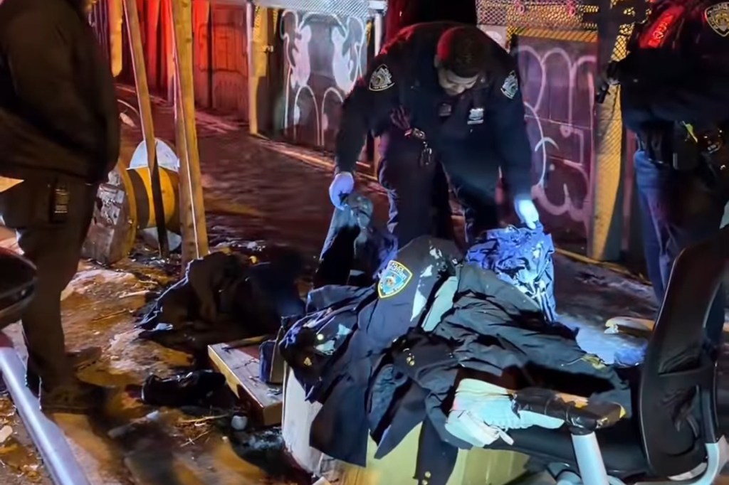 Police officers examine discarded police uniforms.