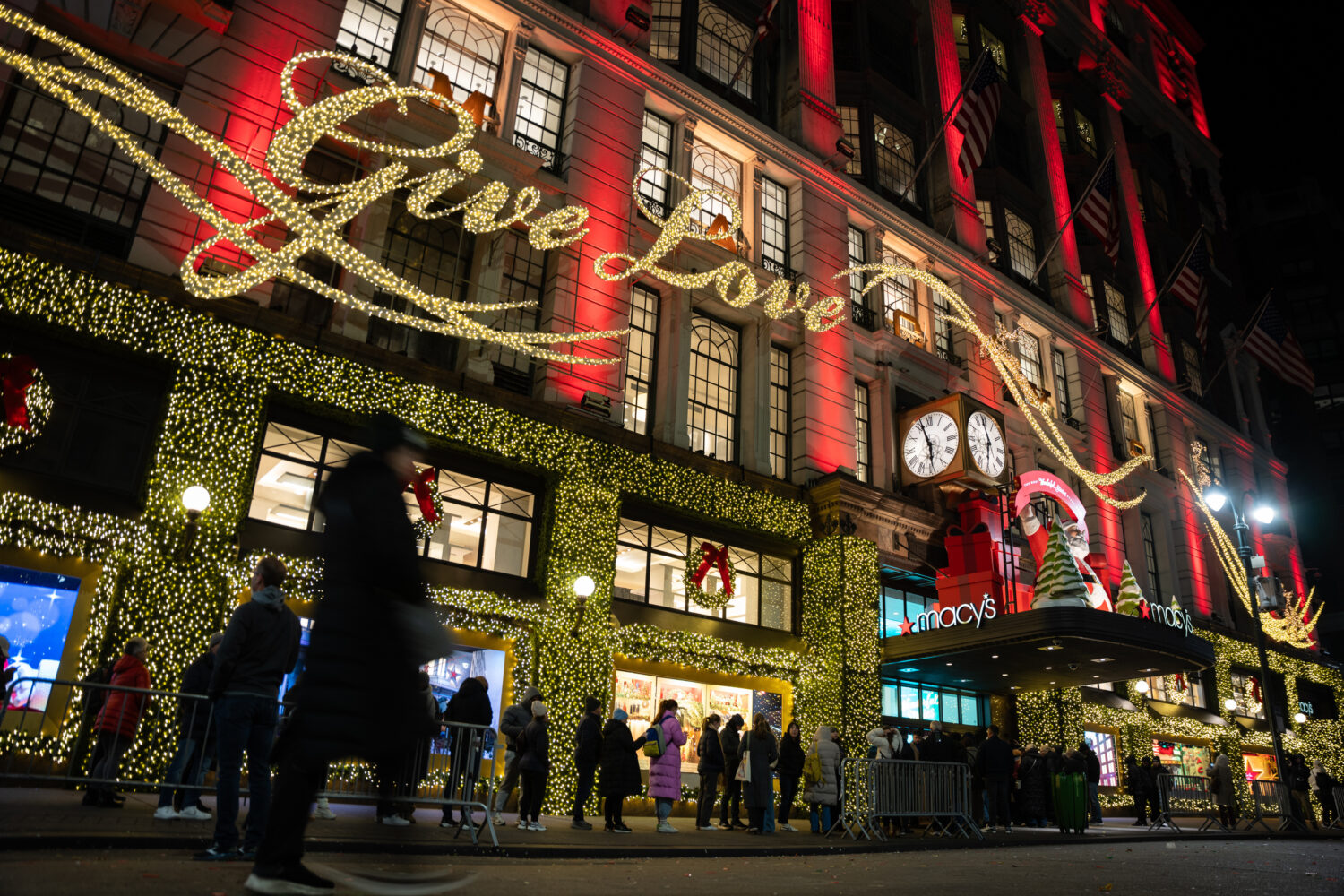 FILE - Shoppers wait in line to enter Macy's flagship store on Friday, Nov. 28, 2025 in New York. (...