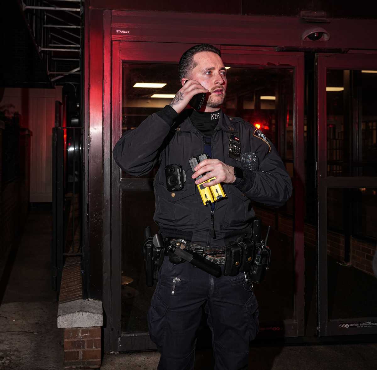 cop holding tasers outside Brooklyn hospital