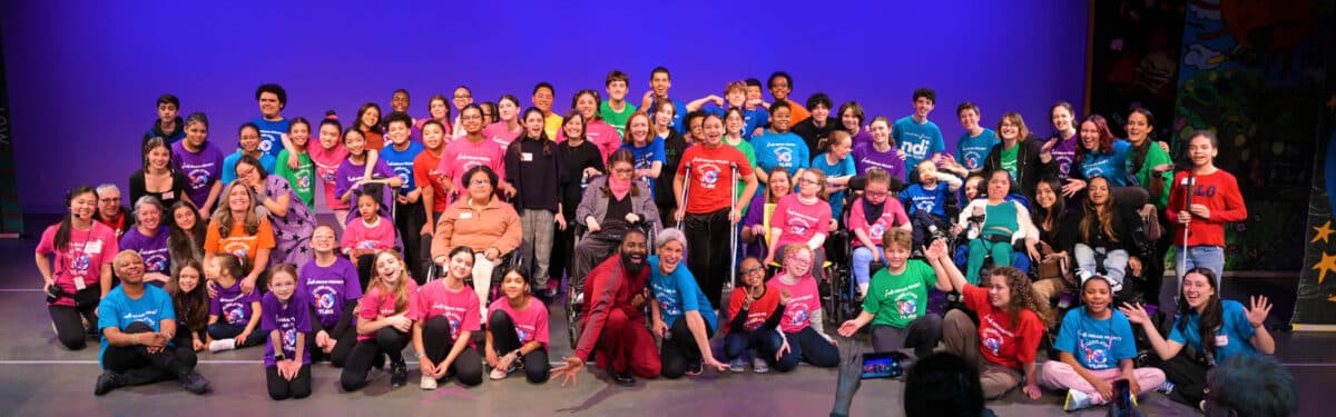 Alameda Post - A large group photo of diverse dangers onstage in colorful outfits. 
