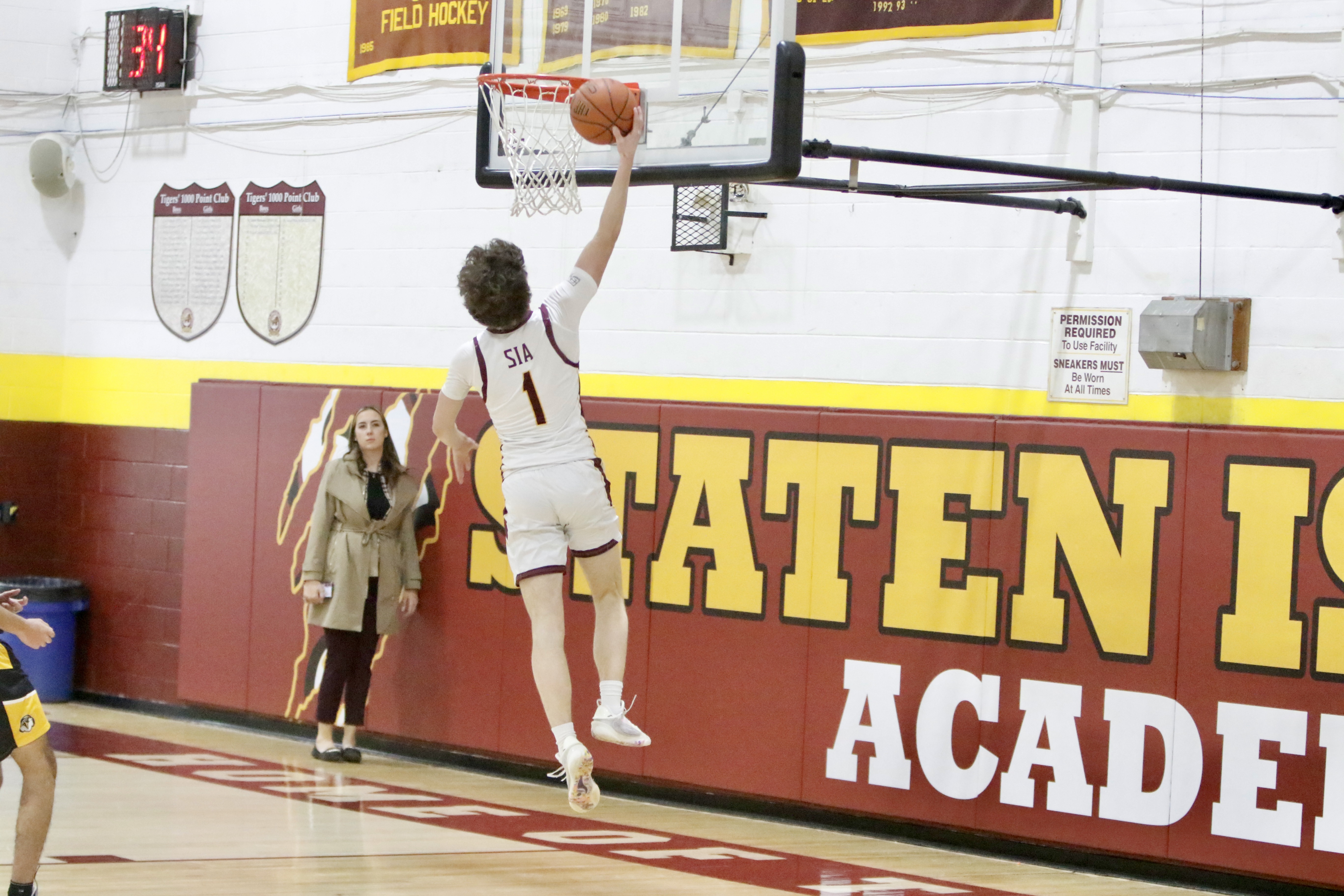 Staten Island Academy's Danny Nowak rises to the rim for a layup during a matchup against Avenues on Jan. 14, 2025.